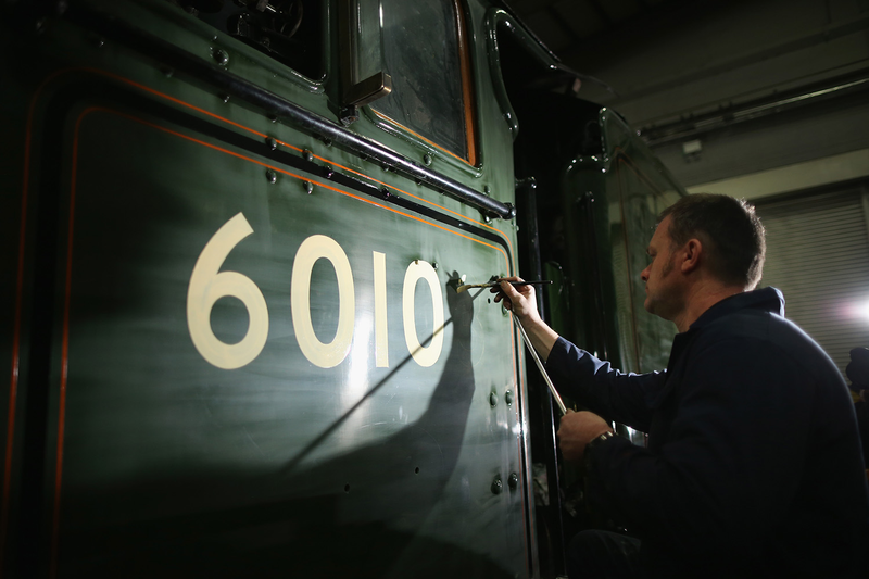 Heritage painter Mike O’Connor paints engine number 60103 onto the side of the Flying Scotsman’s cab, at the National Railway Museum in York, ahead of its official return to steam next week. February 17, 2016 in York, England. (Photo by Christopher Furlong/Getty Images)